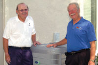 David Hutchins in front of newly installed heat pump with customer