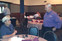 Bobby Pratt (left), Pratt Electric, Lebanon, Tenn., listens as Chris Campbell, vice president of Tradewinds Climate Systems, answers a question about duct-free products manufactured by Gree.