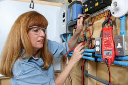 A Gateway Technical College HVACR student examines a new alternative energy system, on equipment provided by Questech and Amatrol, at one of six learning labs implemented in conjunction with Trane and the National Coalition of Certification Centers (NC3).