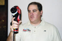 Magic Touch Mechanical technician Jim Watson, a BPI-certified Building Analyst and Envelope Specialist, conducts a whole-home infrared scan as part of a whole-home energy audit