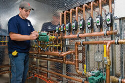 A technician with Woburn, Mass.-based Central Cooling and Heating installs a variable-speed Delta-T Taco circulator and eight Zone Sentry zone valves for a new homeâs radiant heat system.