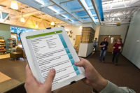 NREL Engineer Nicholas Long uses simuwatt Energy Auditor on his iPad to audit the lighting in a cafÃ© on NRELâs campus