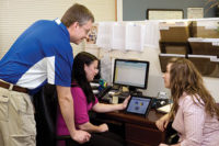 Dave Bloom, left, a PBCI-Allen comfort specialist, looks over a Wrightsoft load diagram with Allison Webster, assistant service manager, and Naomi Schwartz, accounting assistant.