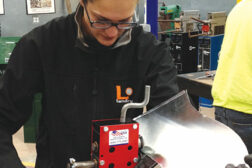 Heidi Brown uses a rotary hand flange forming machine to put a Â¼-inch bend in the metal so it can be placed inside of a Pittsburgh lock to form the duct together.