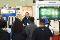 The Affordable Comfort Inc. (ACI) conference also included a trade show. Here, a crowd gathers in front of the Panasonic booth.