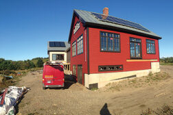 Insource Renewables, Pittsfield, Maine, installed photovoltaic (PV) panels as well as solar collectors for a combisystem (water and space heating) on the back roof of this home in Searsmont, Maine.