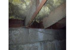Picture of heavily-water damaged and moldy crawl space timbers, insulation, and masonry walls in a flood-damaged house in Sedona, Arizona.