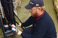 Ryan Brown, a technician for AirTight Mechanical in Charlotte, North Carolina, services a portable R-22 system used for data center hot spots. (Photo courtesy of AirTight Mechanical)