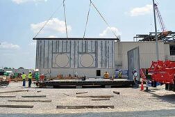 Blue Grass Chemical Agent Destruction Pilot Plant craft workers assemble a Control and Support Building/Munitions Demilitarization Building supply air plenum, which will eventually be installed atop the Control and Support Building. 