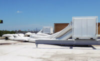 STEEL FRAMES: Temp-Air built steel frames on the roof to set portable cooling units in, with long duct draped over the building that led into the interior space.