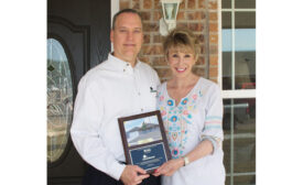 Rick Aldridge (left), president, ClimateMaster Inc., and Ann Felton (right), president of Central Oklahoma Habitat for Humanity, celebrate the 400th home built with geothermal heat pumps donated by ClimateMaster.