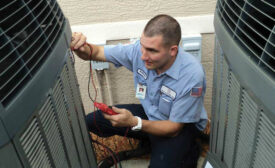 Anthony Leo, a service technician with Advanced Air in Fort Myers, Florida, performs a maintenance reading during a service call.