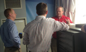 Allen Thomasson II (right) explains to two attendees how some of the Daikin Applied commercial equipment might typically be used on the job.