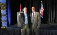 Matt Michel (left), CEO and chairman of Service Nation, and Matt Eversmann (right) pose for a photo during the kickoff keynote address on Sept. 14.