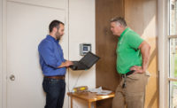 Jackson Willis (left), Mid-Atlantic sales engineer for Fujitsu General America Inc., and Alan Stephens (right), owner of Eco-Green Air in Raleigh, North Carolina, discuss how they plan to approach the installation