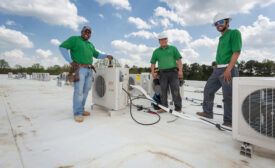 Employees at Raleigh, North Carolina-based Eco Green Air install one of many rooftop condensing units at the Chatham Pointe development in Cary, North Carolina.