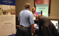 Joann Donelon, director of marketing, White-Rodgers, talks with contractors during the trade show portion of the International Roundtable meeting.