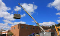 cooling tower being raised onto roof