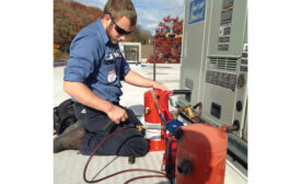 Nick Briggs, service technician, Pleune Service Co., Grand Rapids, Michigan, works on a unit. When it comes to service work, the company uses overtime as a tool to dampen demand during peak times - The NEWS - ACHR