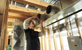 A student at the training center for SMART Local 265 in Carol Stream, Illinois, practices duct installation.