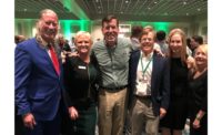 From left: John Hazen White Jr., Cheryl Merchant, Dan Holohan, and other members of the Taco “family” celebrate 100 years at the company’s evening party.