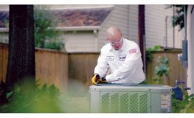 A One Hour technician works on a customer’s air conditioning.