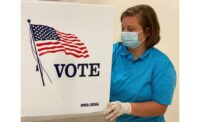 An ROTC Cadet sanitizes a voting station in Lawrenceburg, Kentucky.