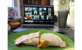 An employee at SupplyHouse.com shows off her quesadilla to the rest of the staff.