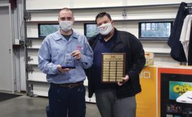 Swift Services installer/tech Josiah Kidman (left) receives the Employee of the Year award from general manager Shane Bedgood.