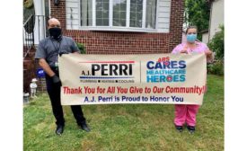 Andrew Gamatko, plumbing manager for A.J. Perri, and nurse Carla Biondi stand in front of Biondi’s home.