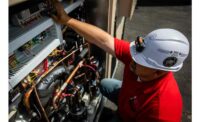 A technician from Jett’s Specialty Contracting works on a unit at an elementary school.