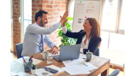 Male and Female Coworkers High Fiving