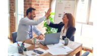 Male and Female Coworkers High Fiving