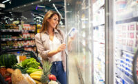 Woman at supermarket cooler.