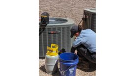 Technician Servicing HVAC Unit