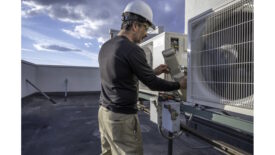 HVAC technician working on RTU